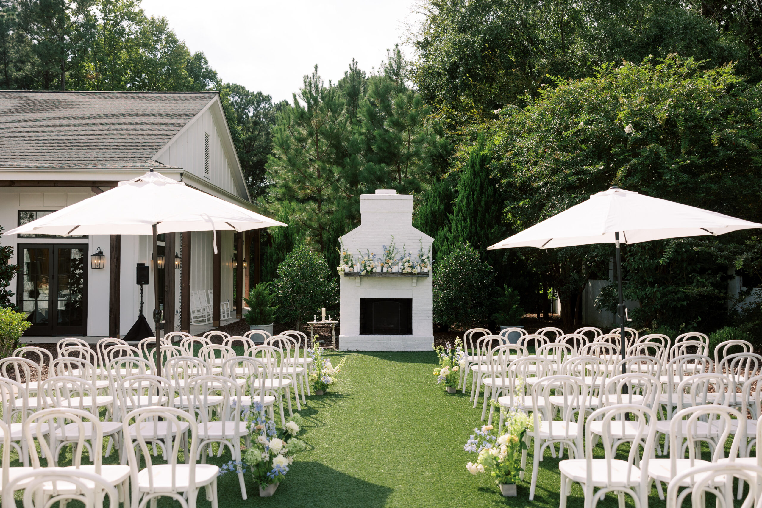 A lush outdoor wedding ceremony setup in North Carolina, featuring abundant floral arrangements, elegant seating, and a scenic backdrop.