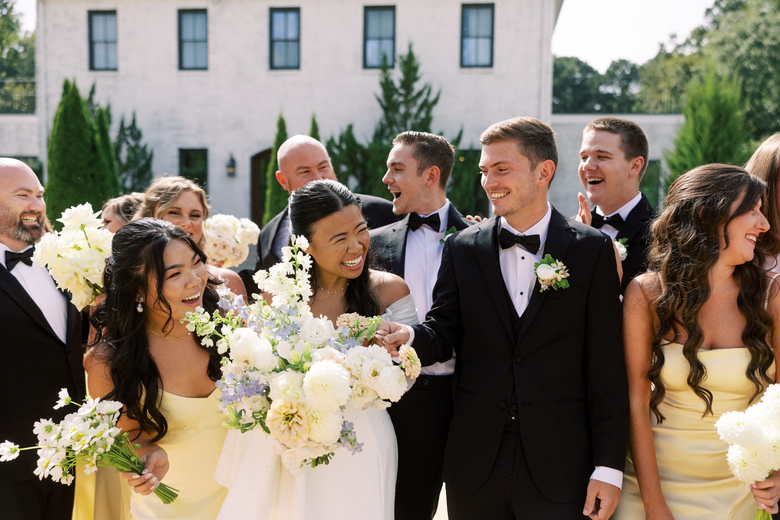 Bride and groom with wedding party The Bradford North Carolina Wedding Venue, showcasing elegant wedding attire and timeless love.