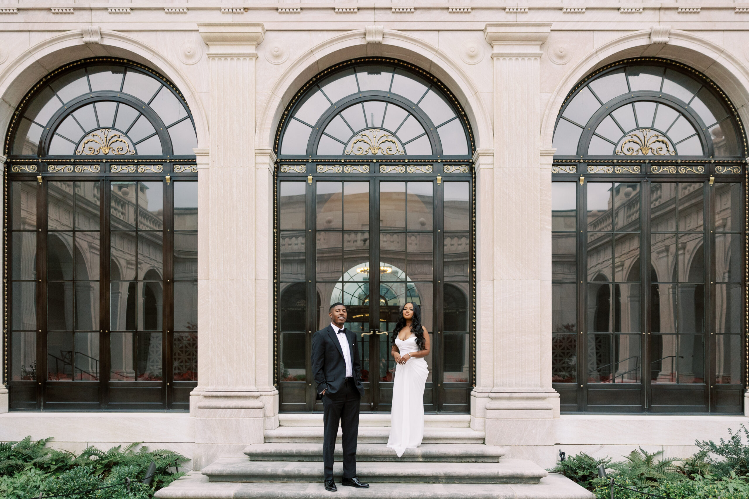 A couple posing elegantly in front of the ornate architecture of The Library of Congress during their Washington, DC engagement session.