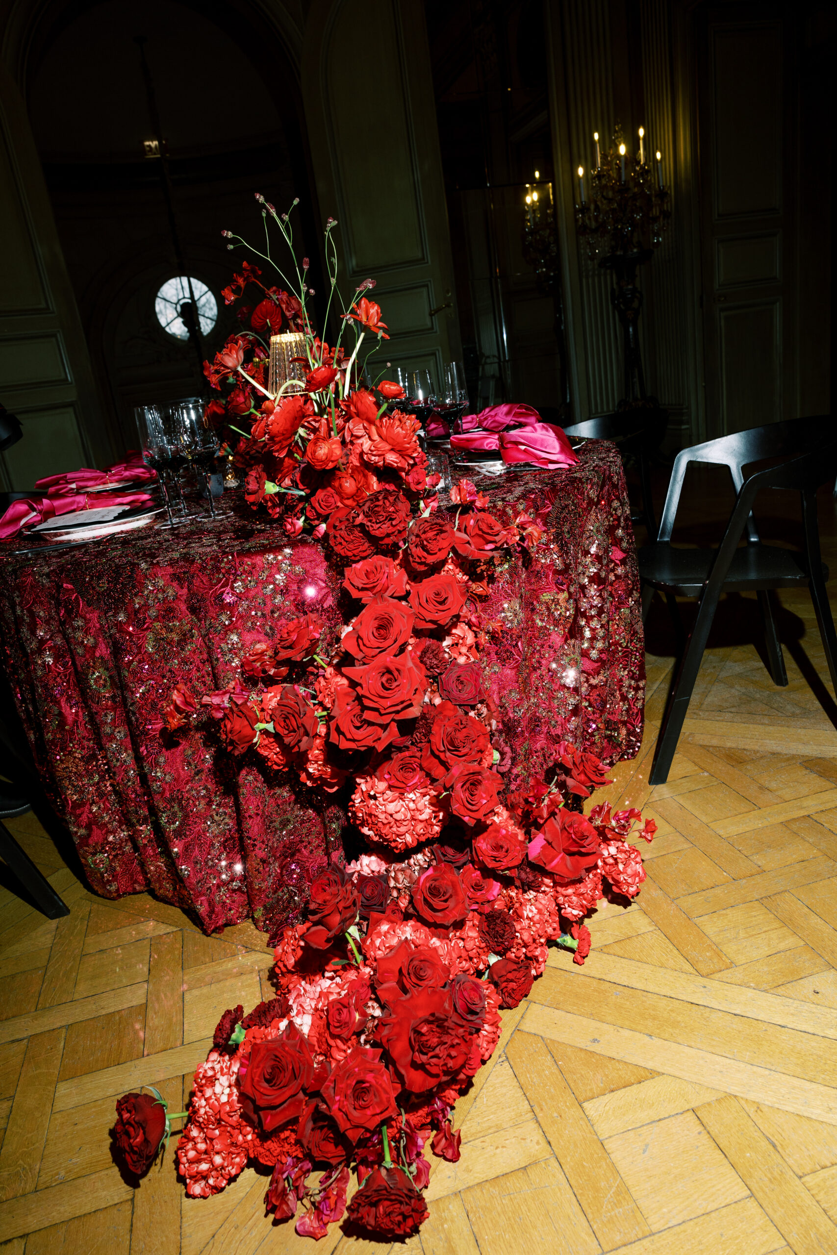 red florals cascading from wedding reception table