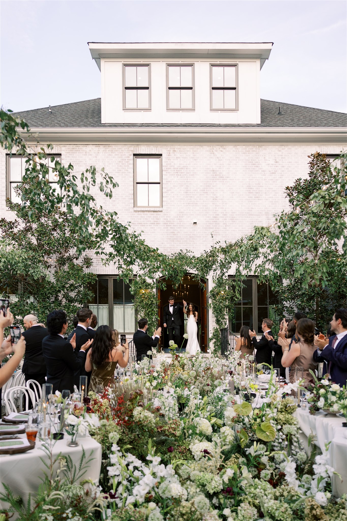 European-inspired courtyard reception at The Bradford near Raleigh NC with curved floral-filled tables